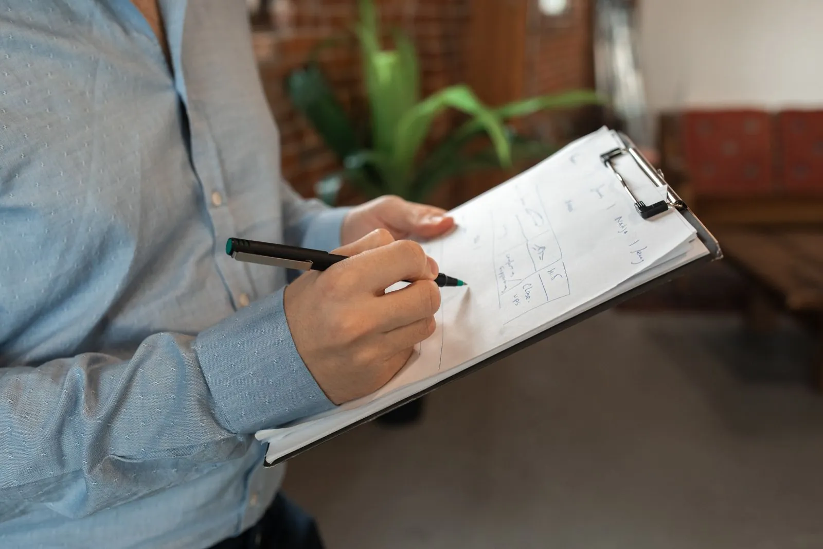 Person taking notes on a clipboard